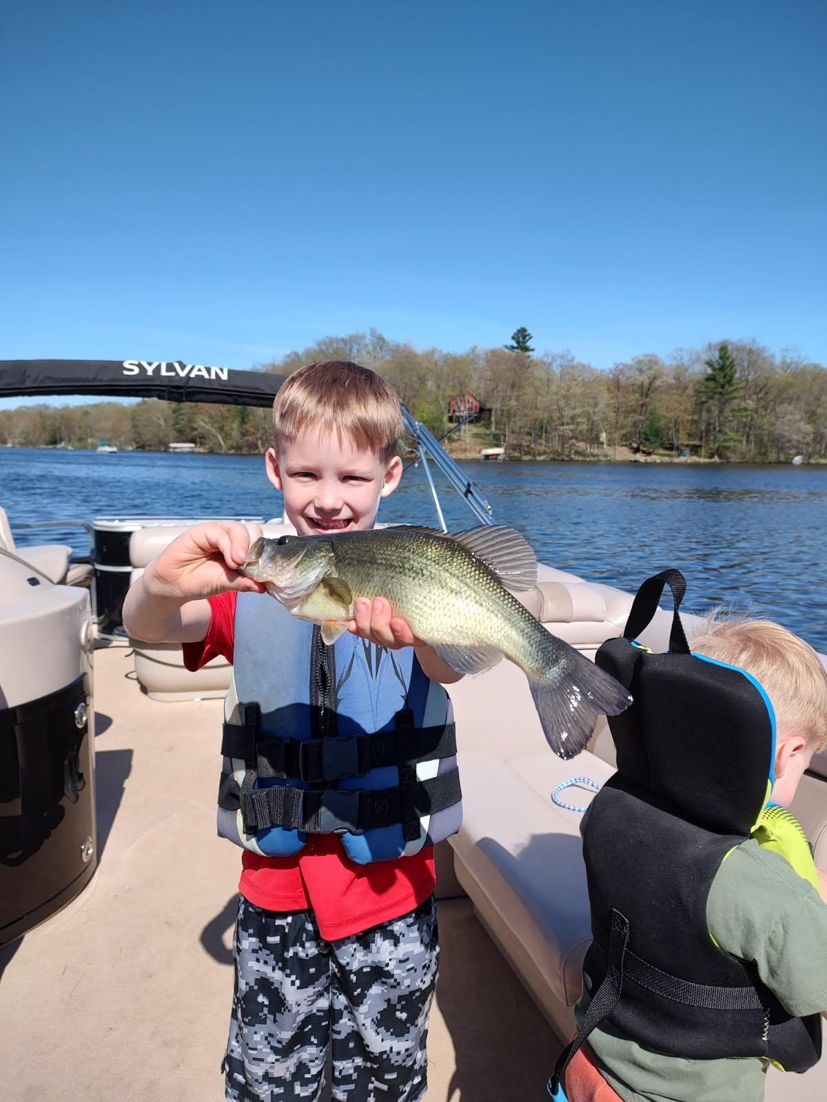 Kid with a fish on the lake